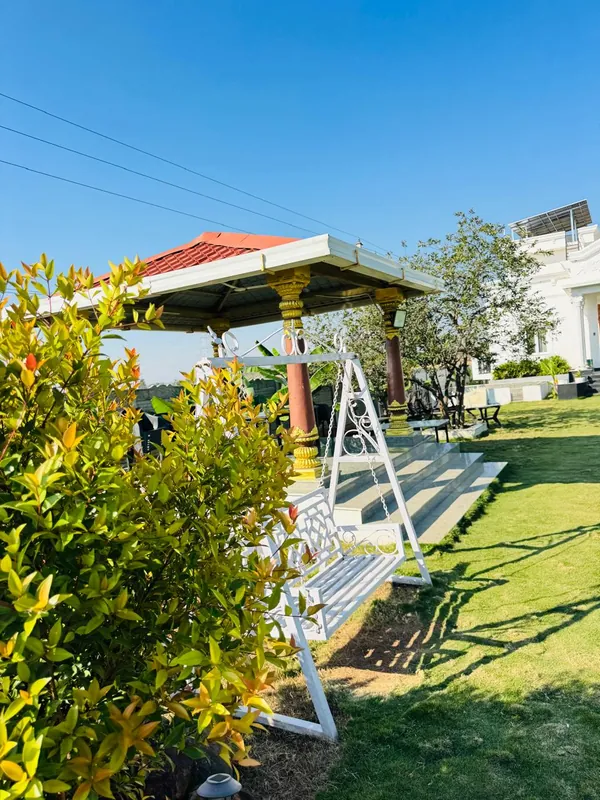 Garden swing and gazebo seating at Green Haven Sports Villa near Hyderabad