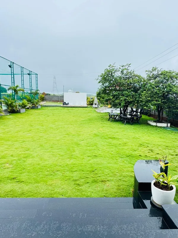 Open farm lawns and green carpet at Green Haven Villa near Hyderabad